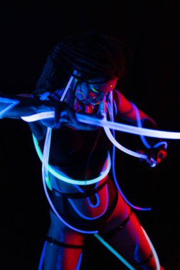 Portrait of a Warror Girl with Glowing Tubes in Neon UF Light. Model Girl with Dreadlocks and Fluorescent Creative Psychedelic MakeUp, Art Design of Female Disco Dancer Model in UV, Colorful Abstract