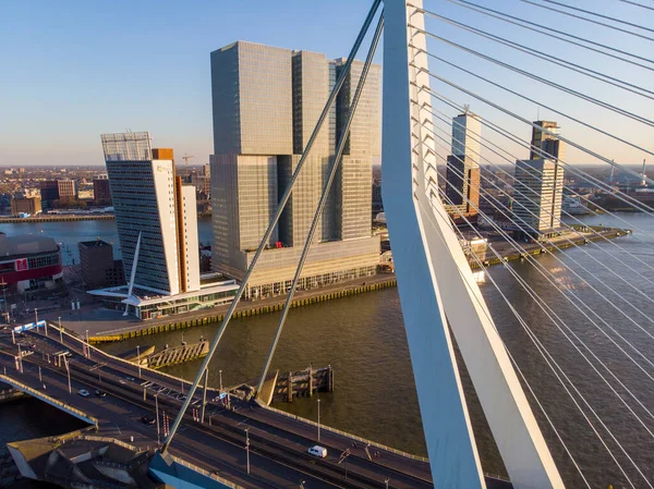 ROTTERDAM, NETHERLANDS: MARCH 2020: Aerial view on the Erasmus Bridge and downtown Rotterdam at evening sunset time — 图库照片