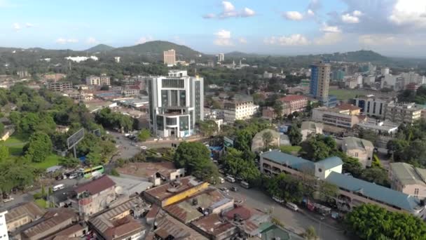 Aerial Close Flyby view of the city of Arusha, Tanzania Mountains and Volcano on Background. — Stock Video