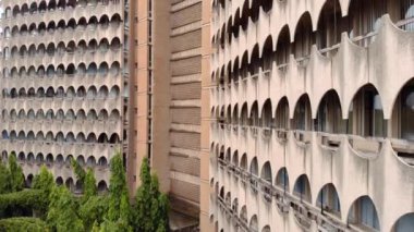 Yatırım Evi 'nin Hava Aracı Çekimi - Dar es Salaam, Tanzanya' da yay panelli garip beton üçgen yüksek bina.