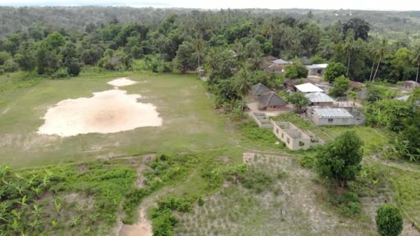 Air Flyby View no campo de futebol africano em pequena aldeia montanhosa remota na Tanzânia, ilha de Pemba, arquipélago de Zanzibar — Vídeo de Stock