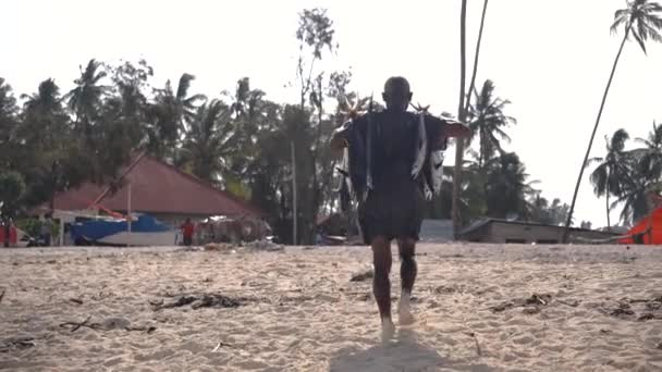 Black African Man is Carrying Tuna Fishes on the Street Fish Market in Nungwi village in s morning after fishing — Stock Video