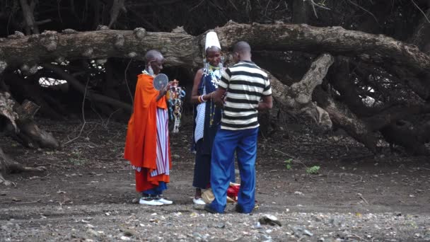 TANZANIA, MASAI VILLAGE - JANUARI 2020: Maasai mensen verkopen hun goederen in inheemse masai dorp Engare Sero aan de kust van Natron Lake in Rift Valley in Maasailand, Arusha district — Stockvideo