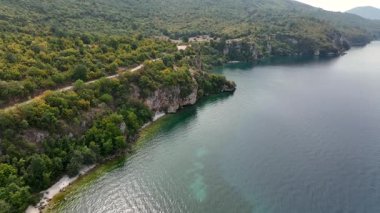 Kuzey Makedonya 'daki Ohri Gölü' nün Wild Cliffy Sahil Şeridi üzerindeki hava manzarası, Balkanlar 'ın en derin ve en eski gölü. Yüksek kalite 4k görüntü