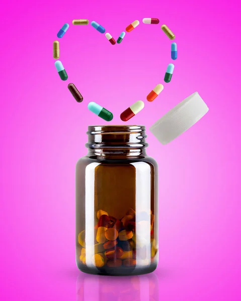 Medicine Bottle Opened Pill Floating Shape Heart Pink Background Concept — Stock Photo, Image