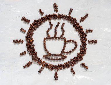 Coffee bean in cup and sun shape on white floor. clipart