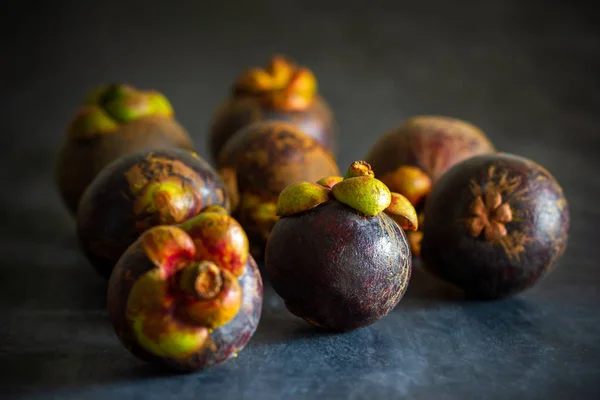 Mangosteen on black cement floor and morning light. — Stock Photo, Image