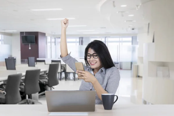 Happy Businesswoman Raising Her Hand Celebrating Success While Reading Good — Stock Photo, Image