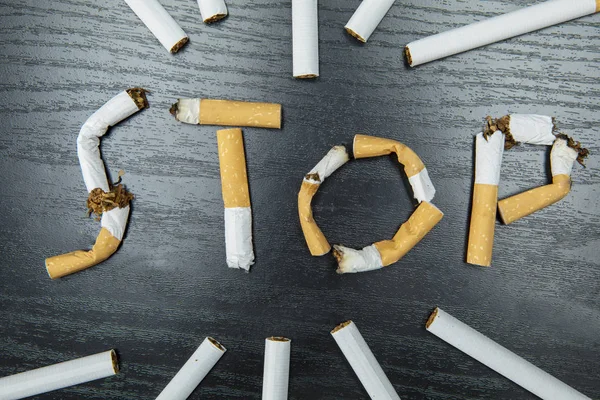 Vista Superior Colillas Cigarrillos Dando Forma Palabra Stop Con Los — Foto de Stock