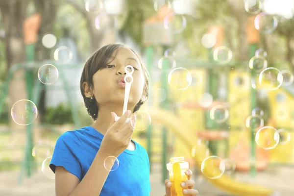 Imagem Menina Adorável Soprando Bolhas Sabão Enquanto Joga Parque Infantil — Fotografia de Stock