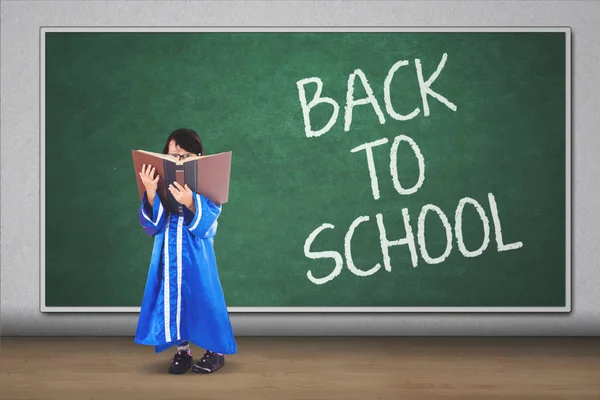 Picture Graduated Little Girl Reading Book While Standing Text Back — Stock Photo, Image