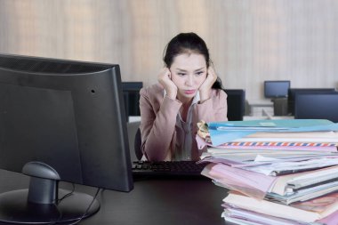 Beyaz işkadını oturma içinde yazıhane evrak yığını yorgun ifade ile bakarken 