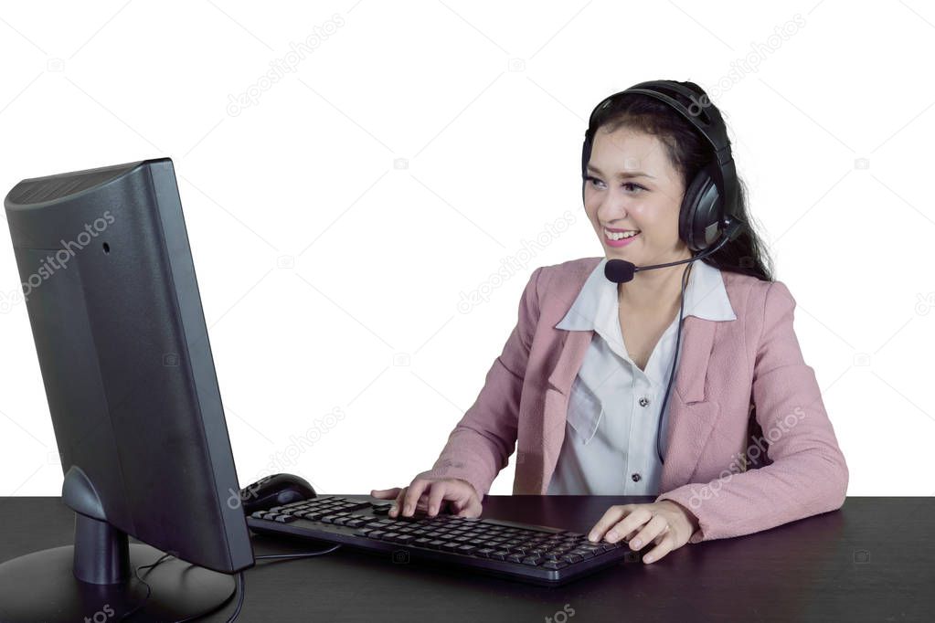 Pretty call center operator working with headphone and computer, isolated on white background