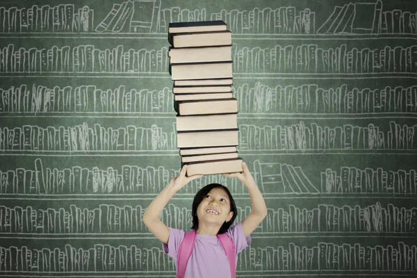 Picture Asian Schoolgirl Lifting Pile Books While Standing Library — Stock Photo, Image