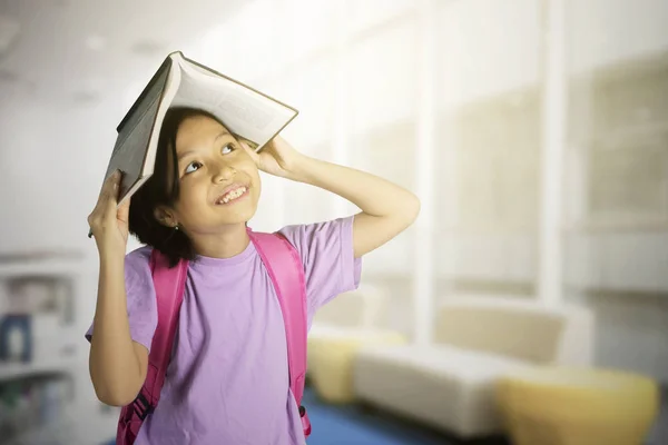 Picture Cute Schoolgirl Puts Open Book Her Head While Thinking — Stock Photo, Image