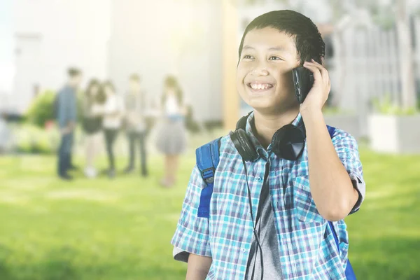 Foto Van Aziatische Preteen Schooljongen Praten Mobiele Telefoon Terwijl Met — Stockfoto