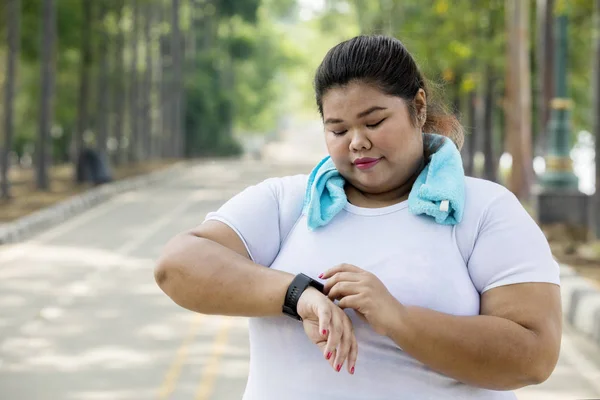 Obrázek Obézní Žena Nosí Její Smartwatch Před Provedením Běhání Silnici — Stock fotografie