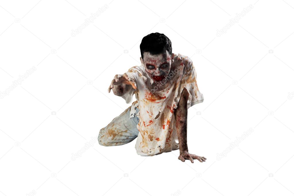 Halloween horror concept. Picture of creepy male ghost crawling with torn clothes in the studio, isolated on white background