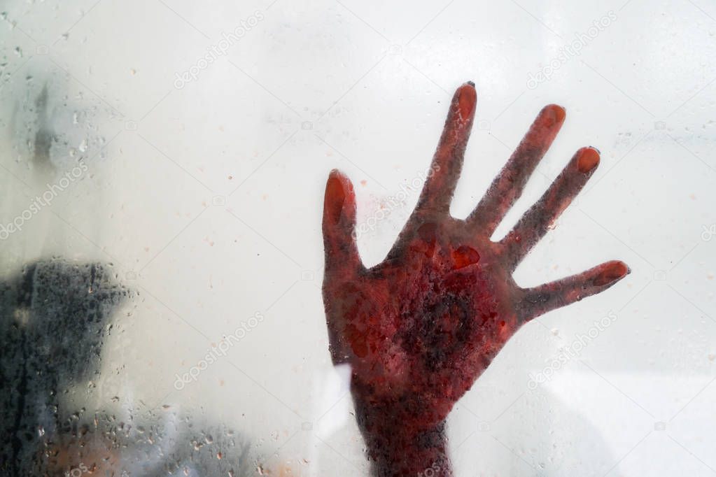 Halloween horror concept. Picture of horrible hand behind glass bathroom window