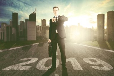 Kol ile sayı 2019 yolda dururken bakarak ABD'li iş adamı