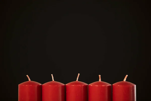 Closeup of Christmas red candles without fire in the dark background