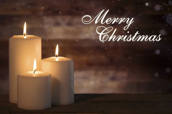 Text Merry Christmas White Candle Glowing Wooden Table — Stock Photo, Image