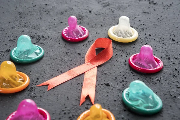 Close Colored Condoms Red Ribbon Table World Aids Day Concept — Stock Photo, Image