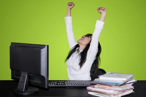 Excited Business Woman Celebrating Success Lifting Her Hands While Working Stock Photo