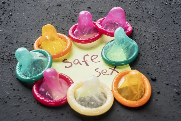 Close Colorful Condoms Safe Sex Text Paper Black Table — Stock Photo, Image