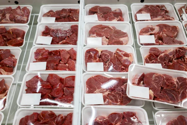 Image of sliced raw meat on the boxes in the supermarket