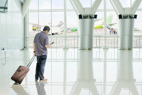 Obrázek Mladý Muž Který Držel Zavazadel Při Používání Mobilního Telefonu — Stock fotografie