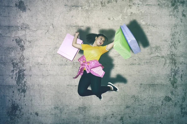 Happy Female Dancer Holding Shopping Bags Jumping Studio Wall Background — Stock Photo, Image