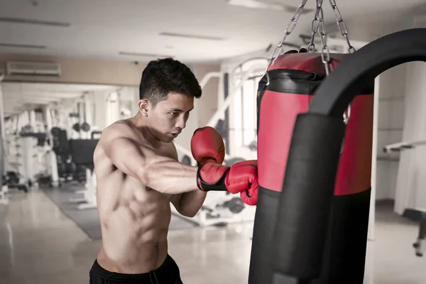 Portrait Handsome Man Punching Boxing Bag Exercising Fitness Center — Stock Photo, Image