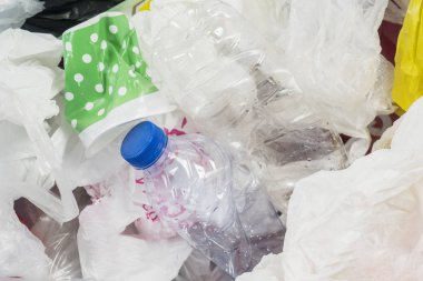 Çöp kutusu atık plastik şişeler ve çantaları ile görüntü. Plastik atık kirliliği kavramı