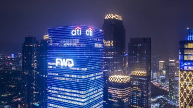 JAKARTA, Indonesia - December 12, 2018: Aerial view of FWD tower with surrounding buildings at night time in South Jakarta  clipart