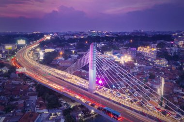 Bandung - Indonesia. January 03, 2019: Aerial view of glowing Pasupati overpass at evening in Bandung city clipart