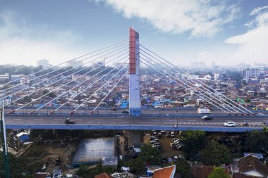 Bandung - Indonesia. January 03, 2019: Aerial view of Pasupati overpass with crowded residential in Bandung city clipart