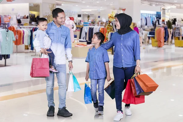 Picture Happy Muslim Family Holding Shopping Bags While Walking Together — Stock fotografie