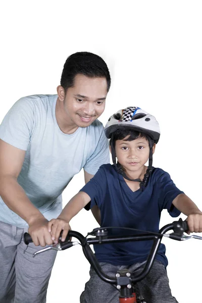 Retrato Jovem Pai Orientando Seu Filho Andar Bicicleta Estúdio Isolado — Fotografia de Stock