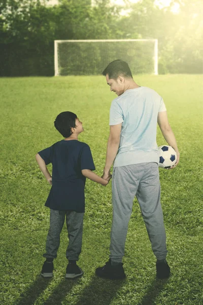 Rear View Little Boy Carrying Ball While Standing His Father — ストック写真