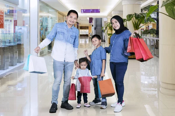 Imagen Sonriente Familia Musulmana Sosteniendo Bolsas Compras Mientras Está Pie — Foto de Stock