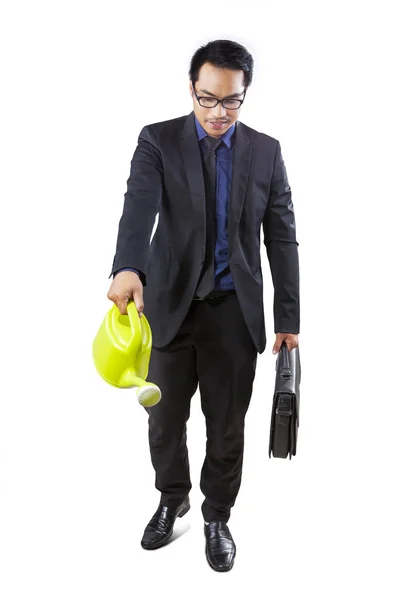 Full Length Asian Businessman Holding Suitcase While Using Watering Can — Stock Photo, Image