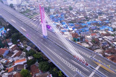 Bandung - Indonesia. February 15, 2019: Top view of Pasupati overpass bridge with dense houses in Bandung city clipart