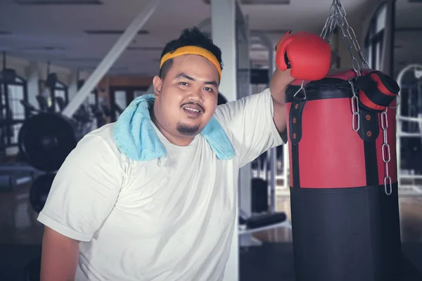 Bild Övervikt Man Ler Kameran Medan Lutande Boxning Väska Sköt — Stockfoto