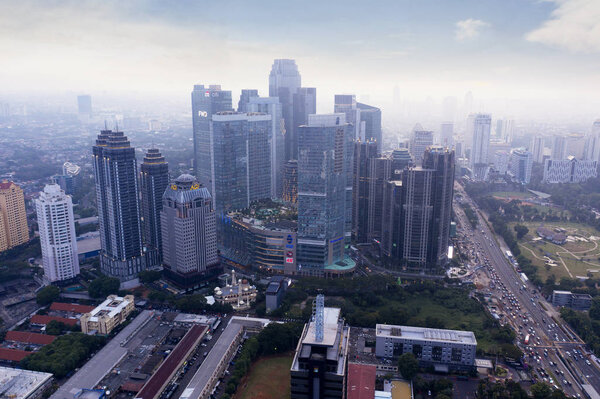 JAKARTA - Indonesia. February 18, 2019: Drone view of high buildings at misty morning in Jakarta city