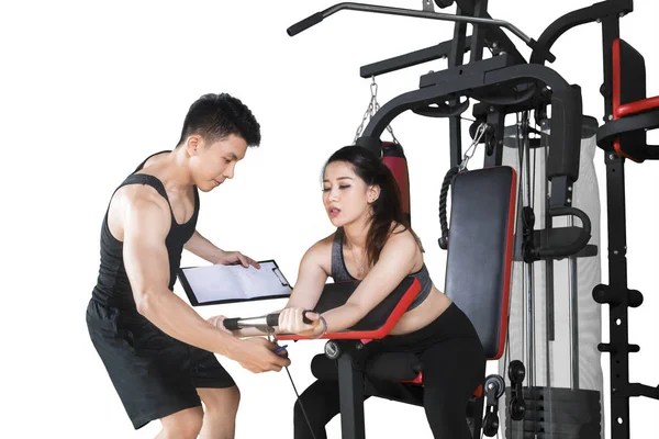 Trainer helps his client to train on studio — Stock Photo, Image