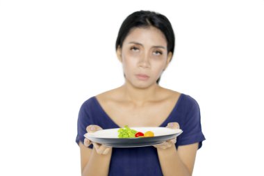 Pale kadın stüdyoda küçük bir porsiyon salata tutar