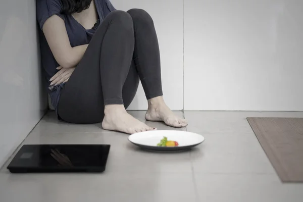 Mulher faminta com salada e balança de peso — Fotografia de Stock