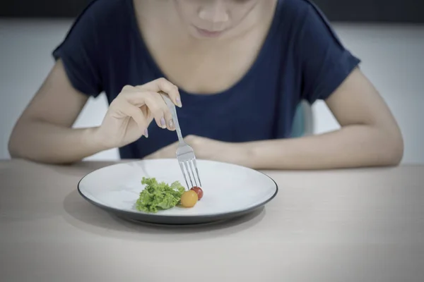 Skinny woman eating small portion salad — Stock Photo, Image