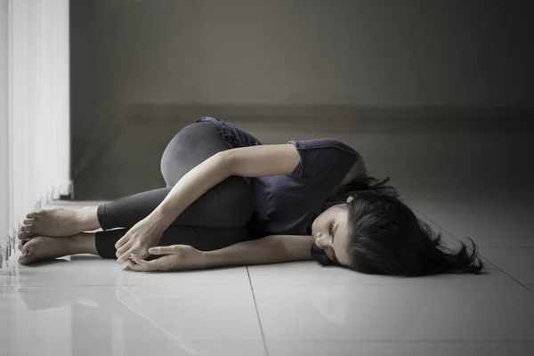 Skinny woman lying on the floor